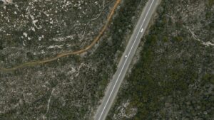 A road and surrounding landscape from above, showcasing the Kentucky Statewide Nadir and Oblique Image Viewer built on Esri technology